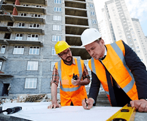 MZ Works tradespeople reviewing building plans on site