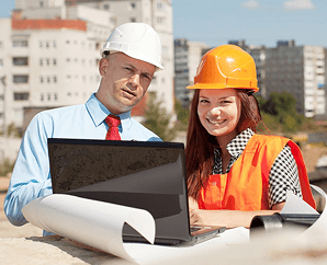 MZ Works site manager and engineer reviewing plans on a laptop on site