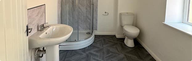 Renovated bathroom with new sink, shower and toilet