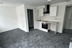 Refurbished room with new white kitchen units
